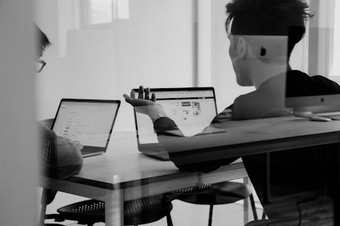2 people having a discussion in a closed office