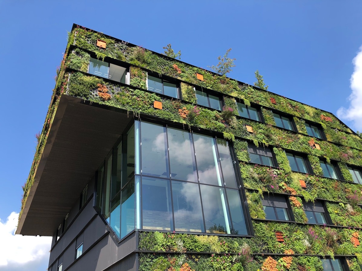 An office building with external living walls with orange plants