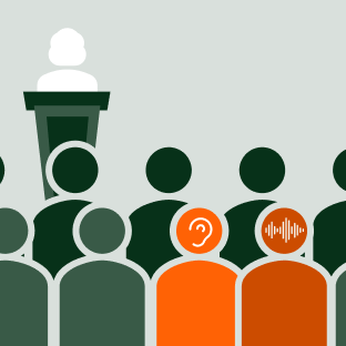 Interpreter in the crowd at a small event whispering to the person next to them