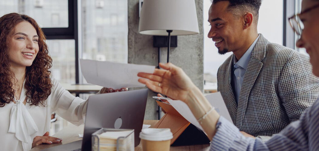 3 people sat at a desk discussing banking needs for a client