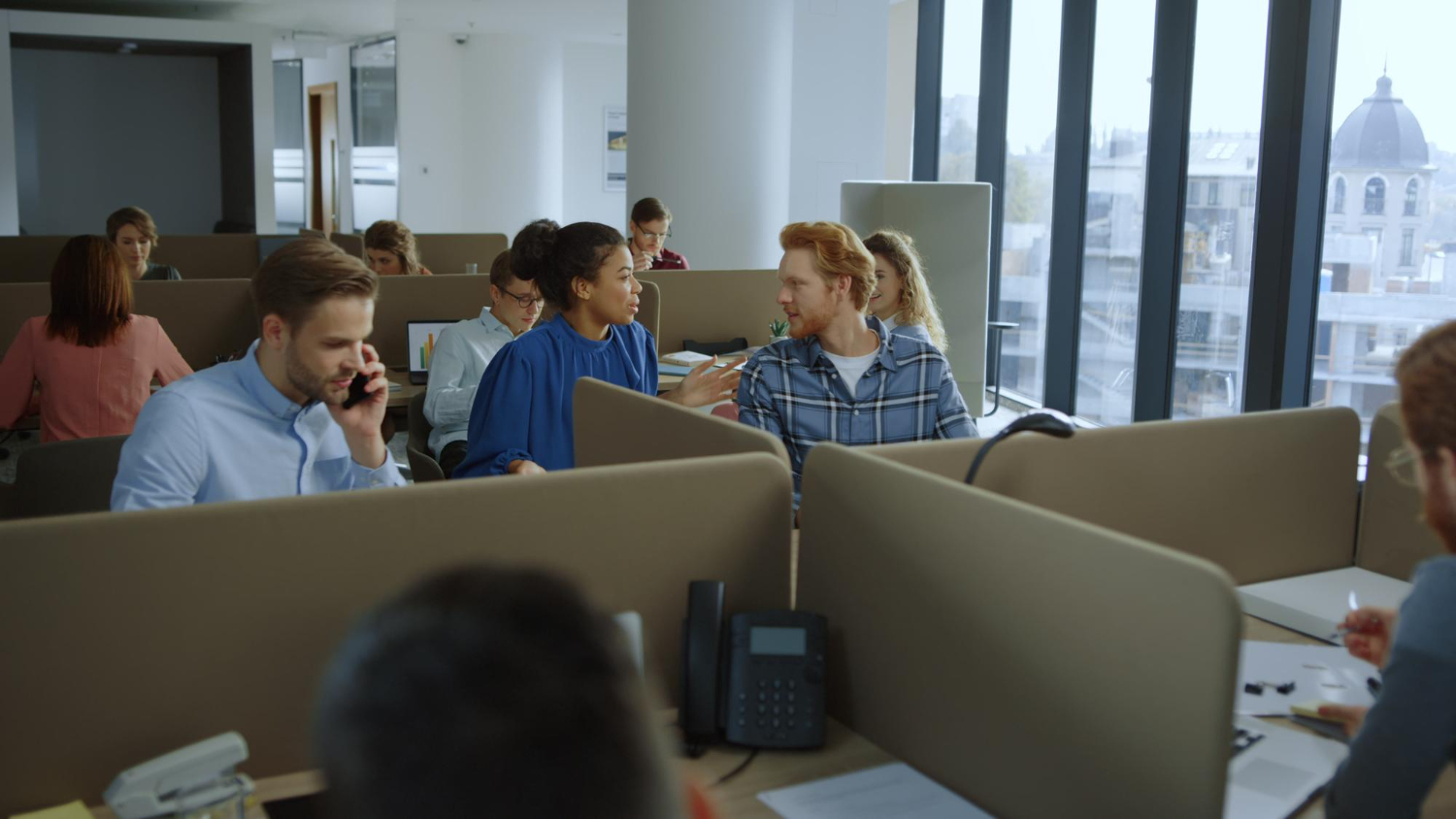 A collection of copy writers and translators working in an open plan office