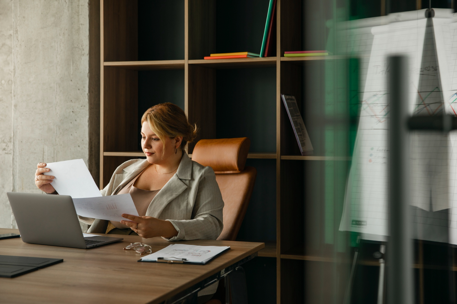 insurance manager sat at desk reviewing accounts
