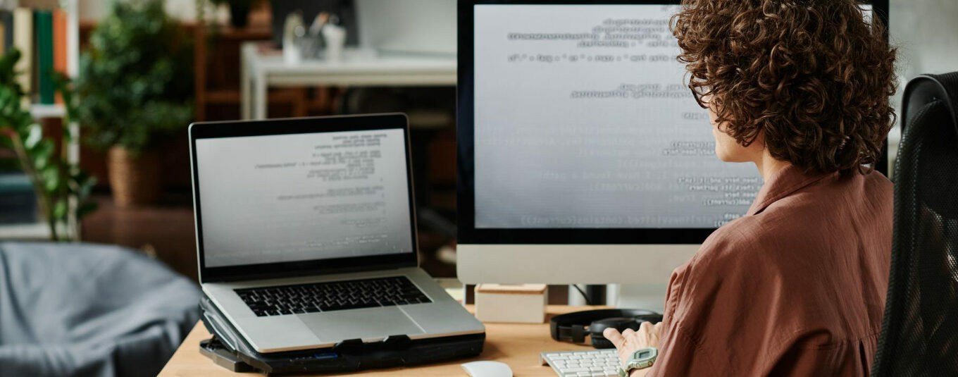 A content writer sites at a desk using a text editor