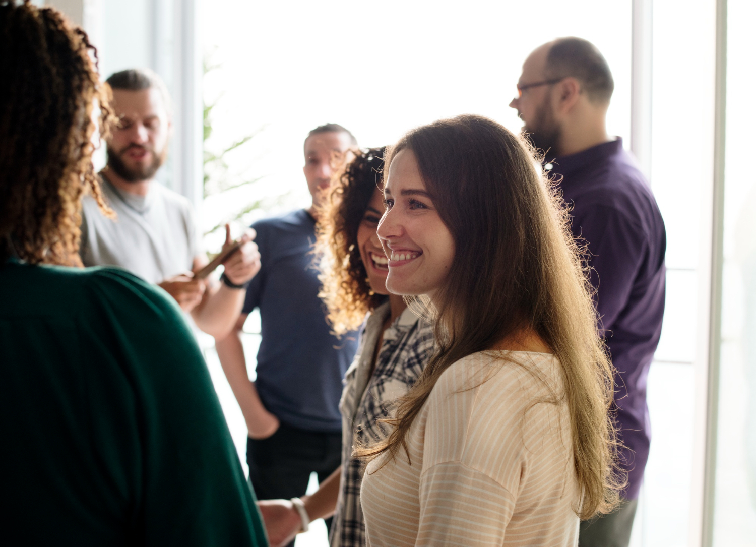 A group of people standing in a group benefitting from good client communication