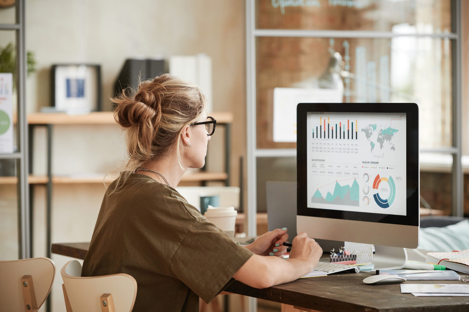 A content analyst sits at her desk auditing content to look for gaps and opportunities
