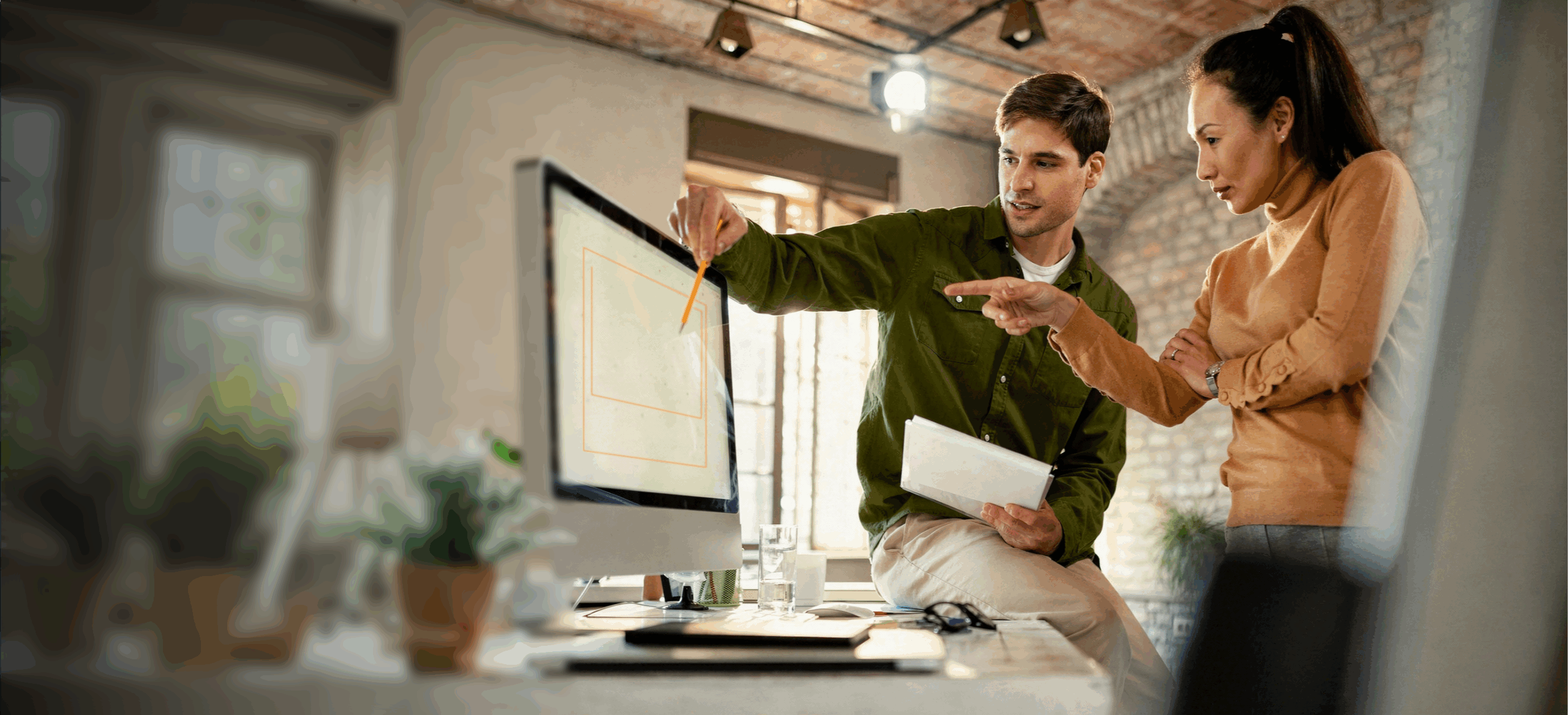 a designer and a project manager have a discussion over a design