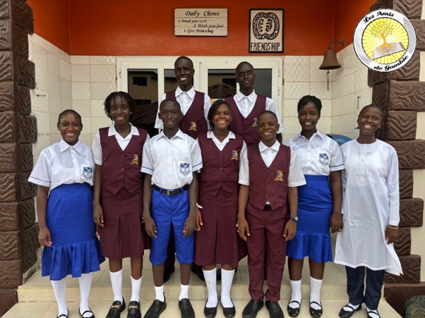 A group of school children from Les Amies de Gambie smiling at the camera