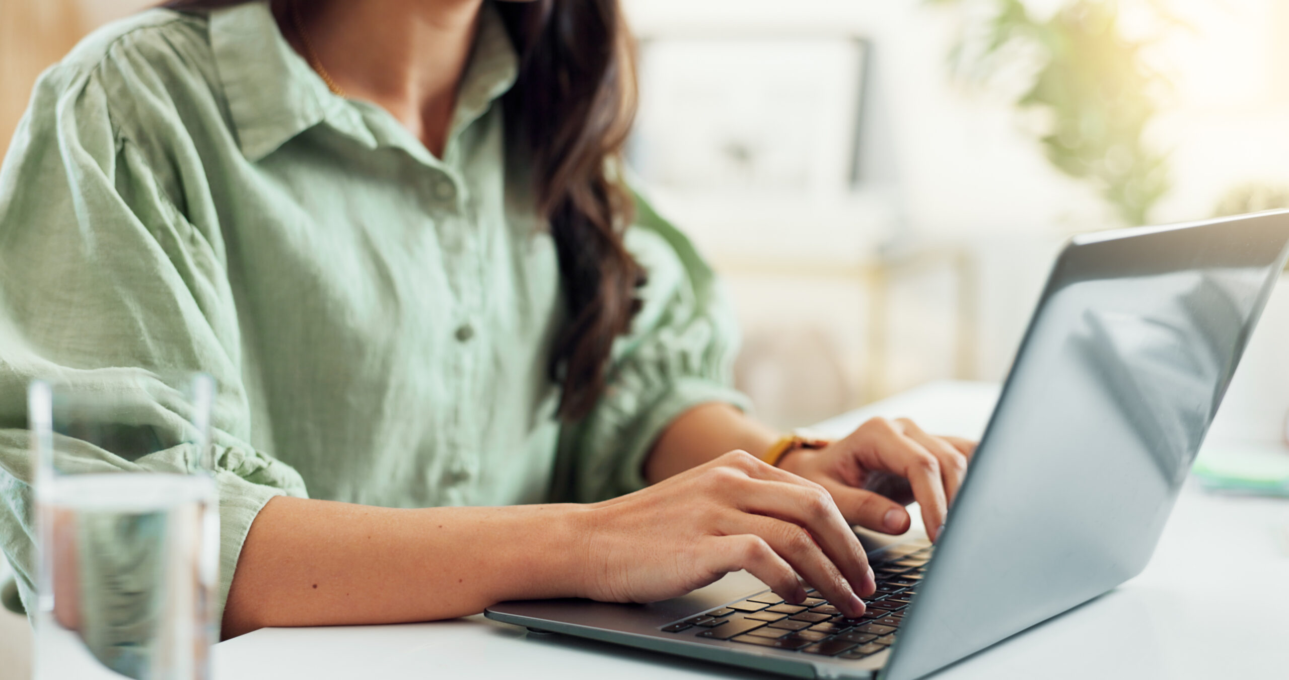 A customer support assistant communicating with clients on a laptop